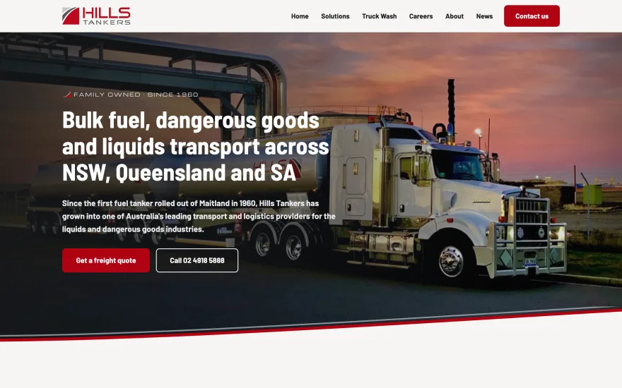 Hills Tankers homepage: a fuel tanker at a depot at dusk under a headline about bulk fuel and dangerous goods transport